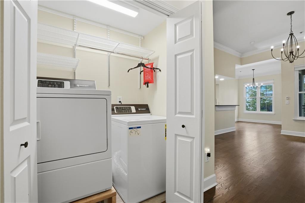 3777 Peachtree Road Northeast, Unit 932 Brookhaven, GA 30319 - Photo 24 of 26 a storage room with wooden floor and cabinets