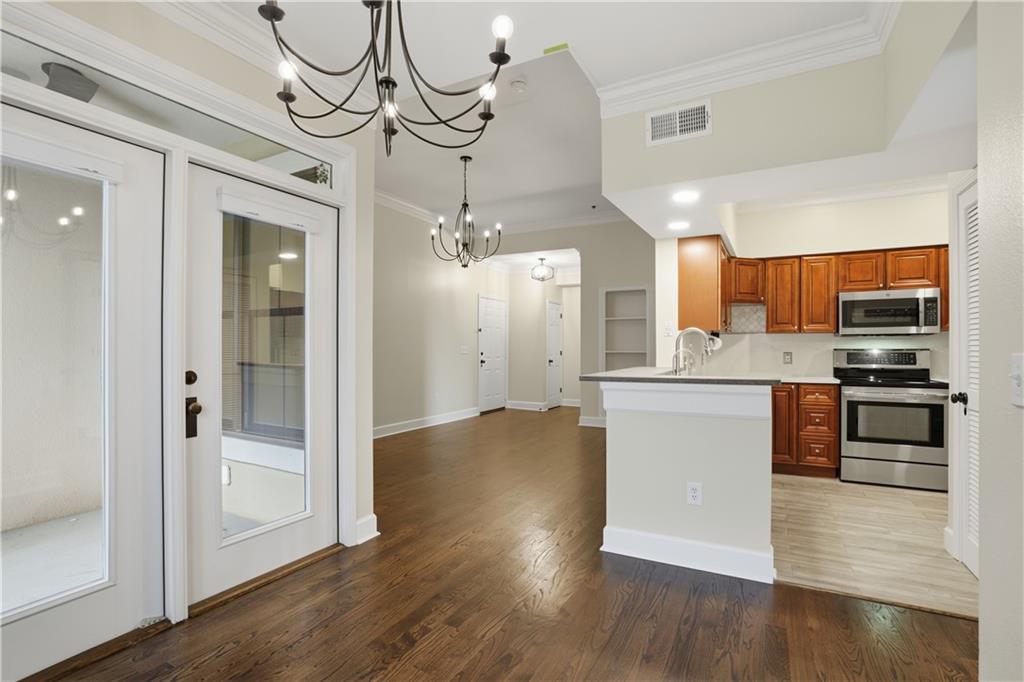 3777 Peachtree Road Northeast, Unit 932 Brookhaven, GA 30319 - Photo 3 of 26 a view of a kitchen center island wooden floor and stainless steel appliances