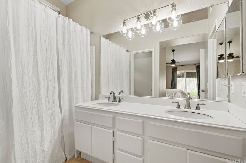 43345 Via Sabino Temecula, CA 92592 - Photo 16 of 22 a bathroom with a double vanity sink and a mirror