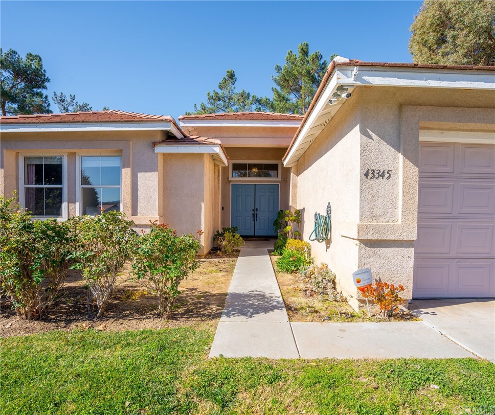 43345 Via Sabino Temecula, CA 92592 - Photo 3 of 22 a front view of a house with garden