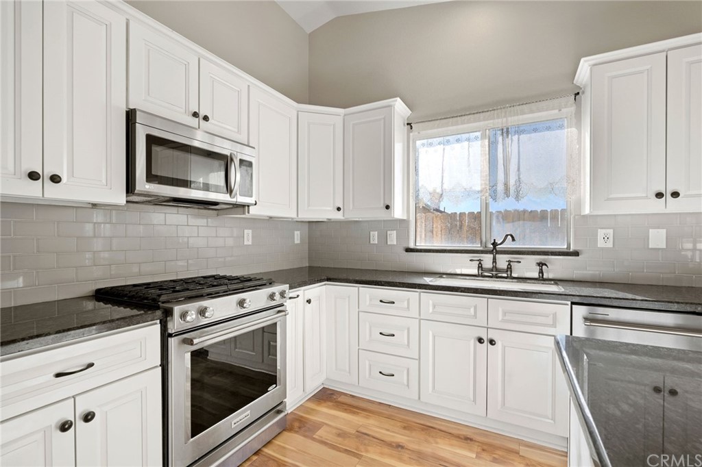 43345 Via Sabino Temecula, CA 92592 - Photo 7 of 22 a kitchen with granite countertop white cabinets and appliances