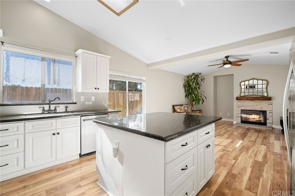 43345 Via Sabino Temecula, CA 92592 - Photo 8 of 22 a kitchen with granite countertop a sink and cabinets