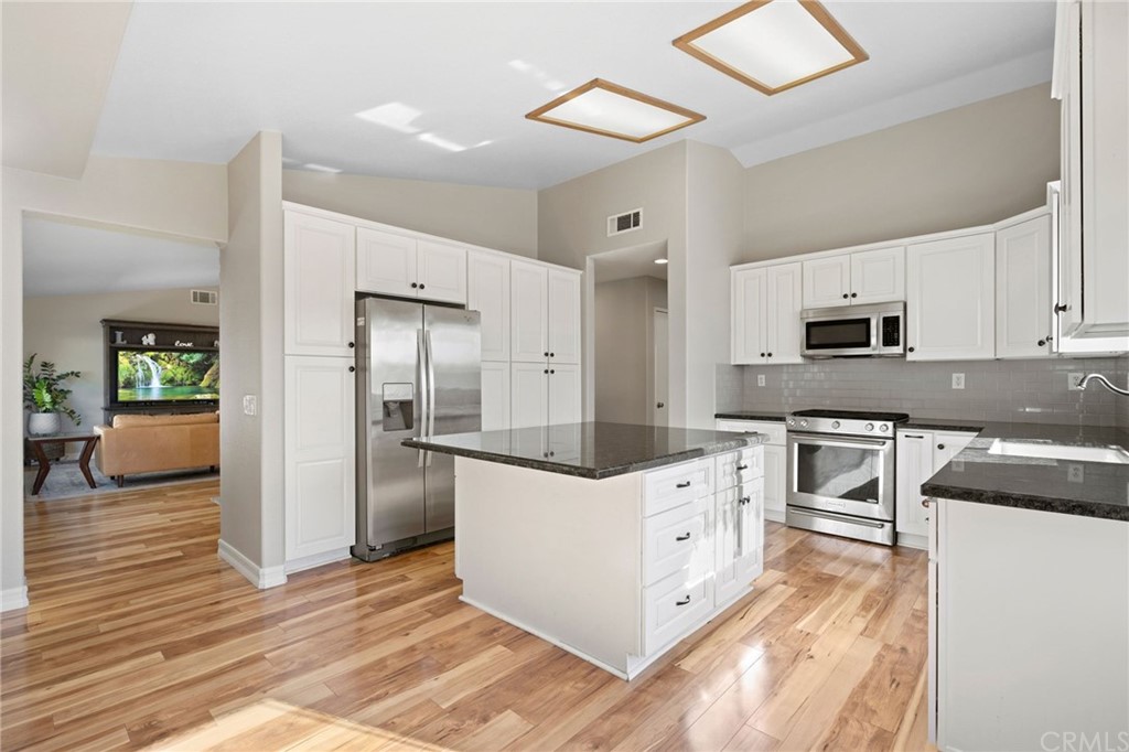 43345 Via Sabino Temecula, CA 92592 - Photo 10 of 22 a kitchen with white cabinets and stainless steel appliances