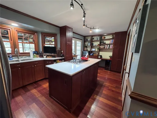 a view of a workspace with furniture and wooden floor