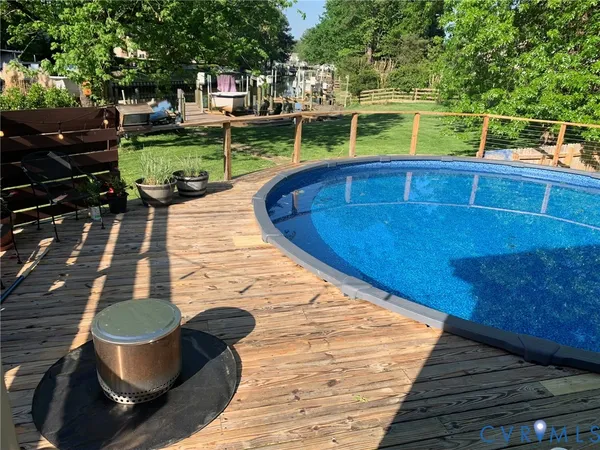 a view of a chair and table in backyard of the house