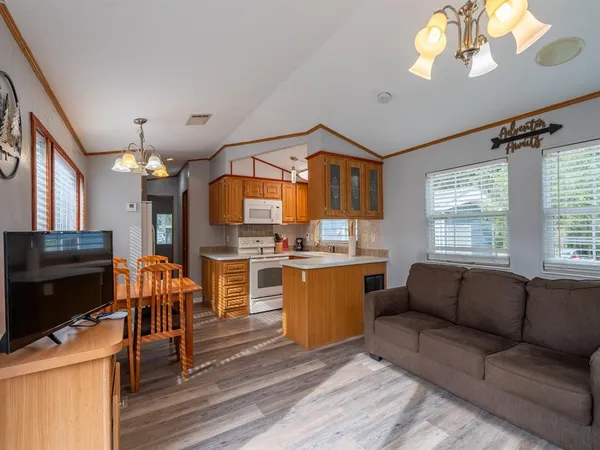 a living room with fireplace furniture and a flat screen tv