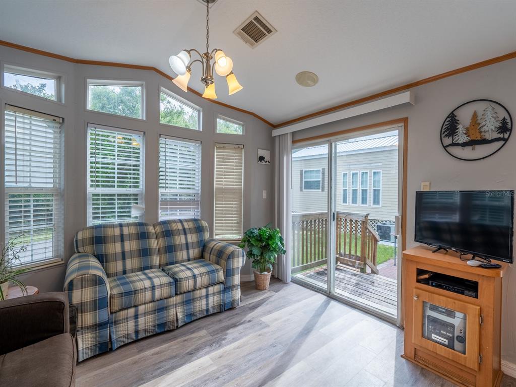 15991 Northeast 243rd Place Road, Unit 32 Fort McCoy, FL 32134 - Photo 13 of 27 a living room with furniture and a flat screen tv