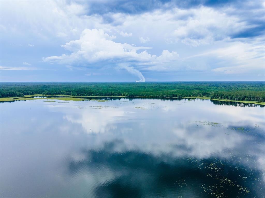 15991 Northeast 243rd Place Road, Unit 32 Fort McCoy, FL 32134 - Photo 23 of 27 a view of a lake with outdoor space