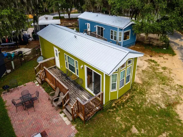 an aerial view of a house with a yard