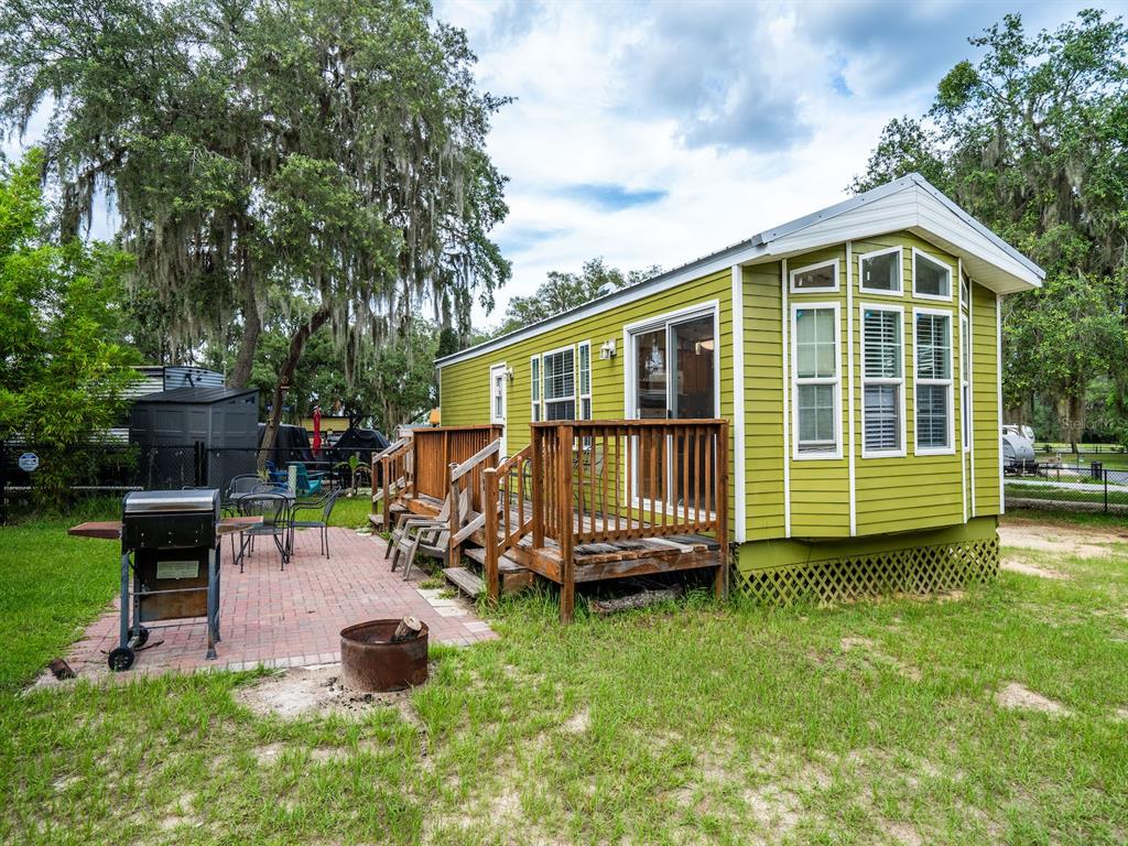 15991 Northeast 243rd Place Road, Unit 32 Fort McCoy, FL 32134 - Photo 4 of 27 a view of a house with a backyard