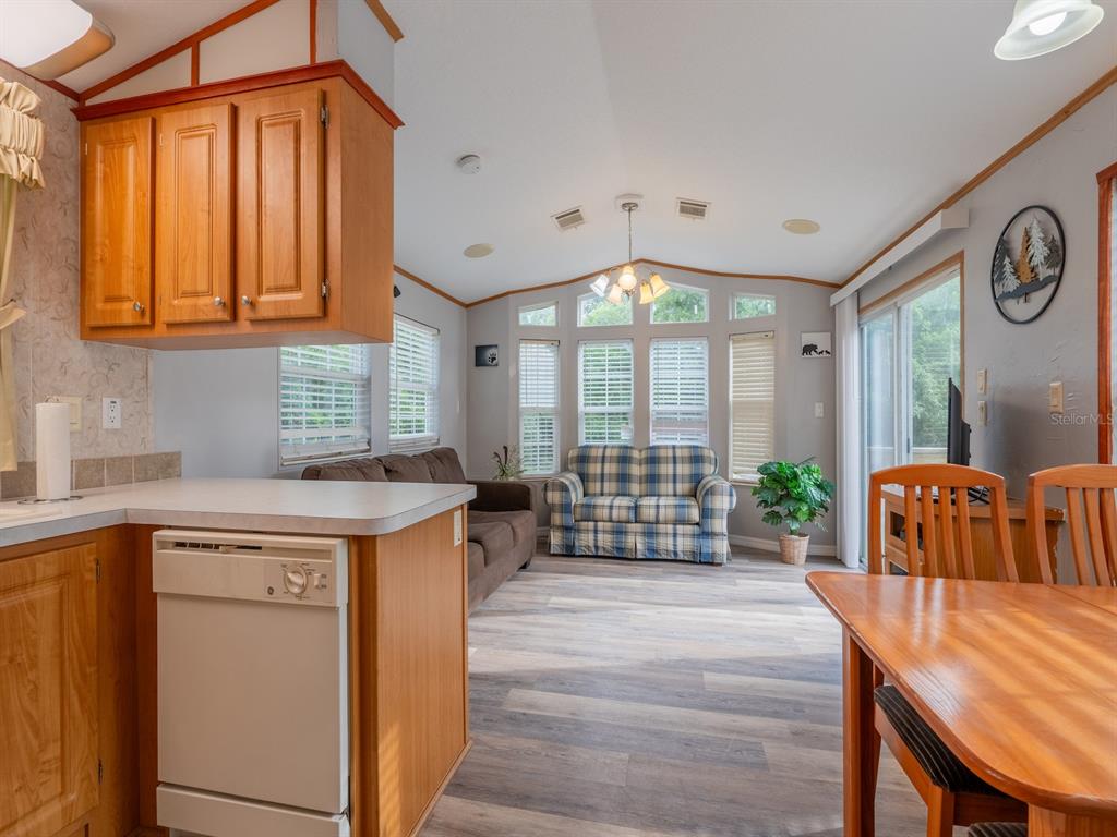 15991 Northeast 243rd Place Road, Unit 32 Fort McCoy, FL 32134 - Photo 8 of 27 a kitchen with stainless steel appliances granite countertop a stove a sink and a refrigerator