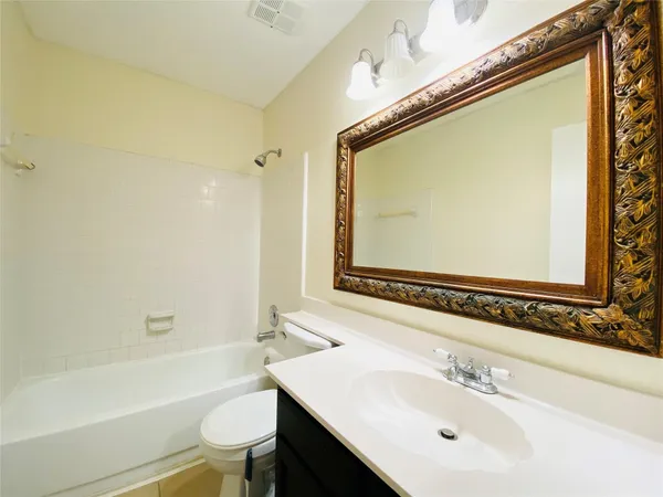 a bathroom with a sink mirror toilet and bathtub
