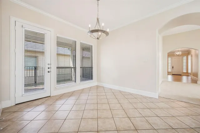 a view of a livingroom with a chandelier fan and windows