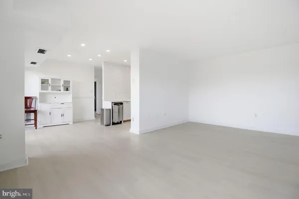 a view of kitchen with furniture and refrigerator