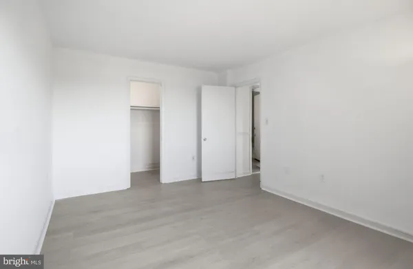 an empty room with a window and mirror