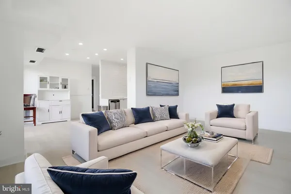 a living room with furniture and a painting