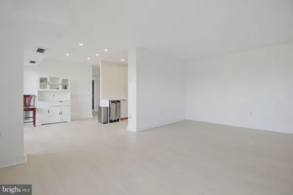 an empty room with furniture and natural light