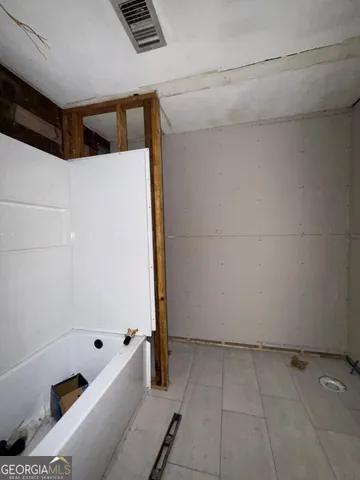 a view of a room with workspace and a window