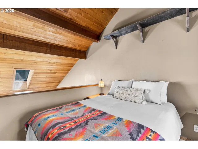 a bedroom with a bed and a night stand