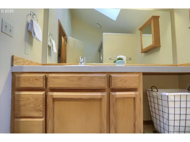a bathroom with a sink a mirror and shower