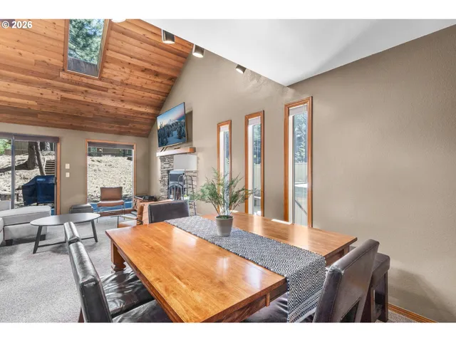 a living room with furniture a large window and wooden floor