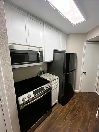 a kitchen with a stove microwave and refrigerator