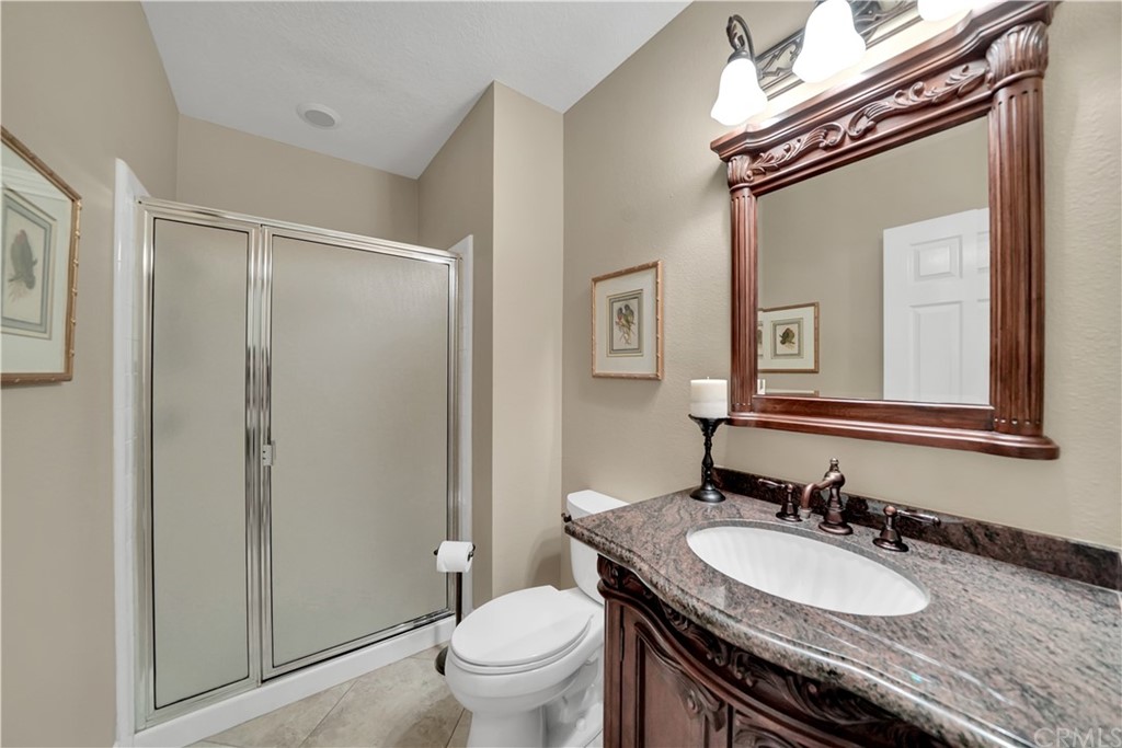 19 Springbrook Road Laguna Niguel, CA 92677 - Photo 17 of 41 a bathroom with a granite countertop sink vanity mirror and toilet