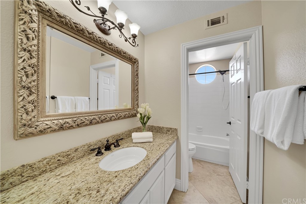19 Springbrook Road Laguna Niguel, CA 92677 - Photo 25 of 41 a bathroom with a granite countertop sink a mirror and shower