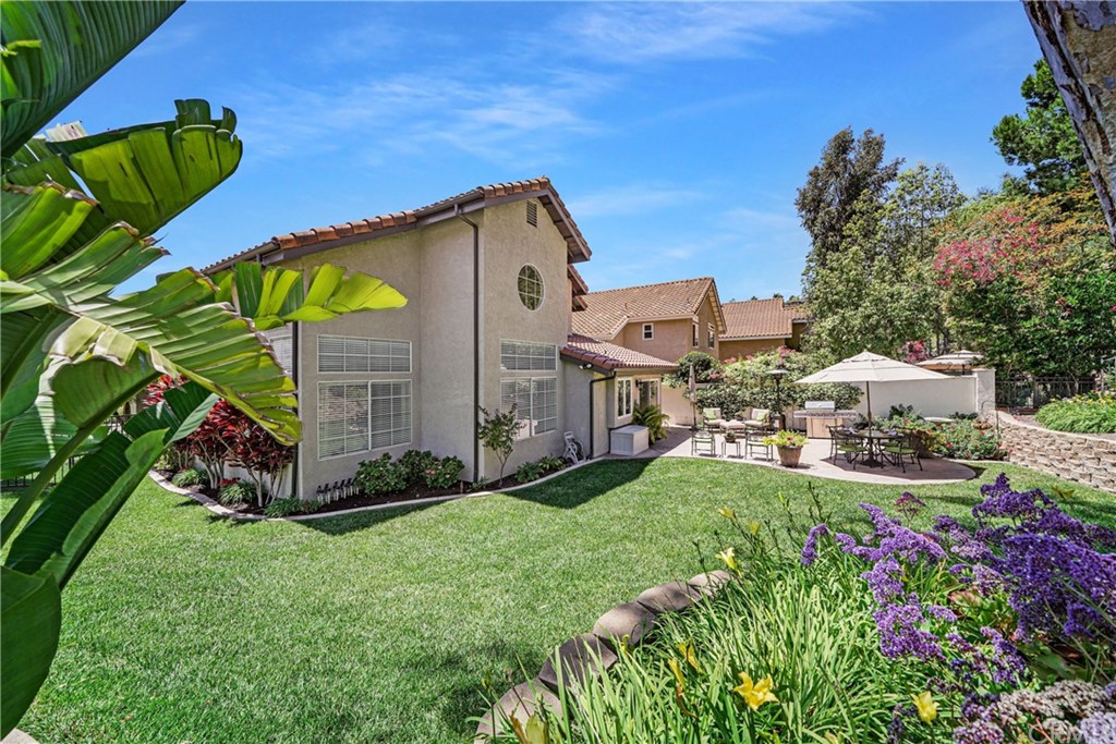 19 Springbrook Road Laguna Niguel, CA 92677 - Photo 31 of 41 a view of a back yard with flower plants and wooden fence