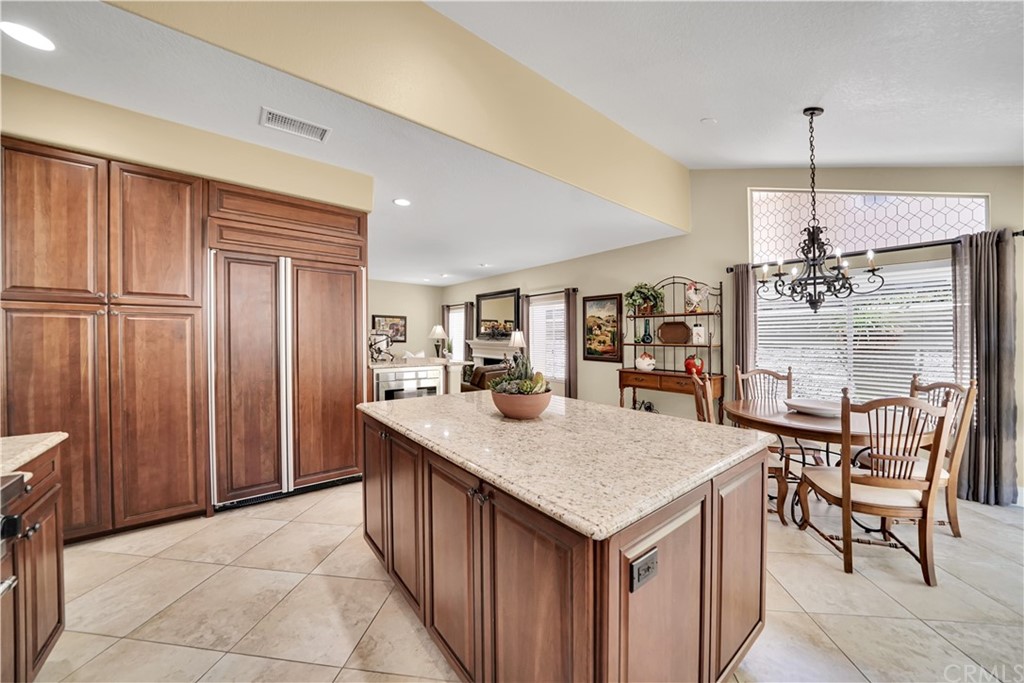 19 Springbrook Road Laguna Niguel, CA 92677 - Photo 9 of 41 a kitchen with a table chairs and refrigerator