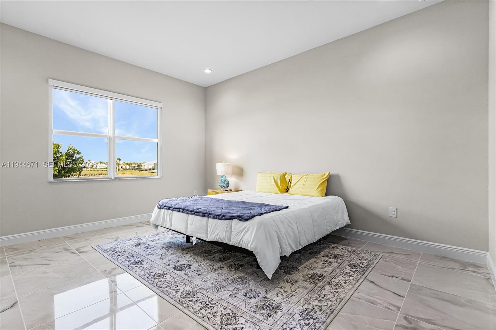 9087 Kite Lane Naples, FL 34114 - Photo 24 of 36 a bedroom with a bed and window