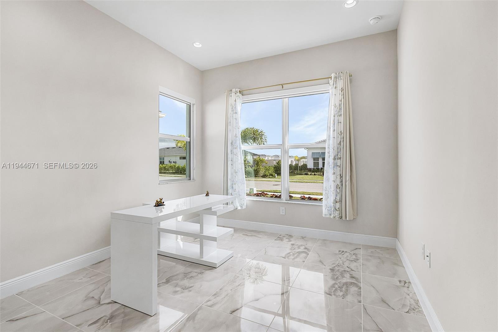 9087 Kite Lane Naples, FL 34114 - Photo 28 of 36 a living room with furniture and a large window