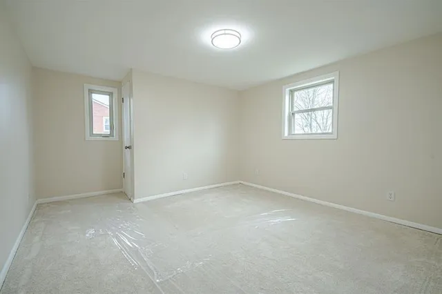 a view of wooden floor and windows in a room