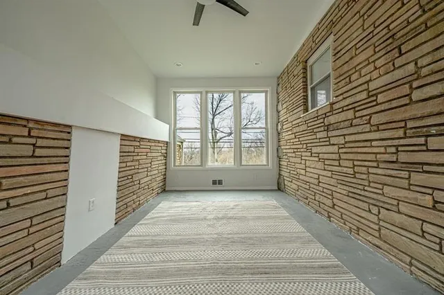 a view of an empty room with a fireplace