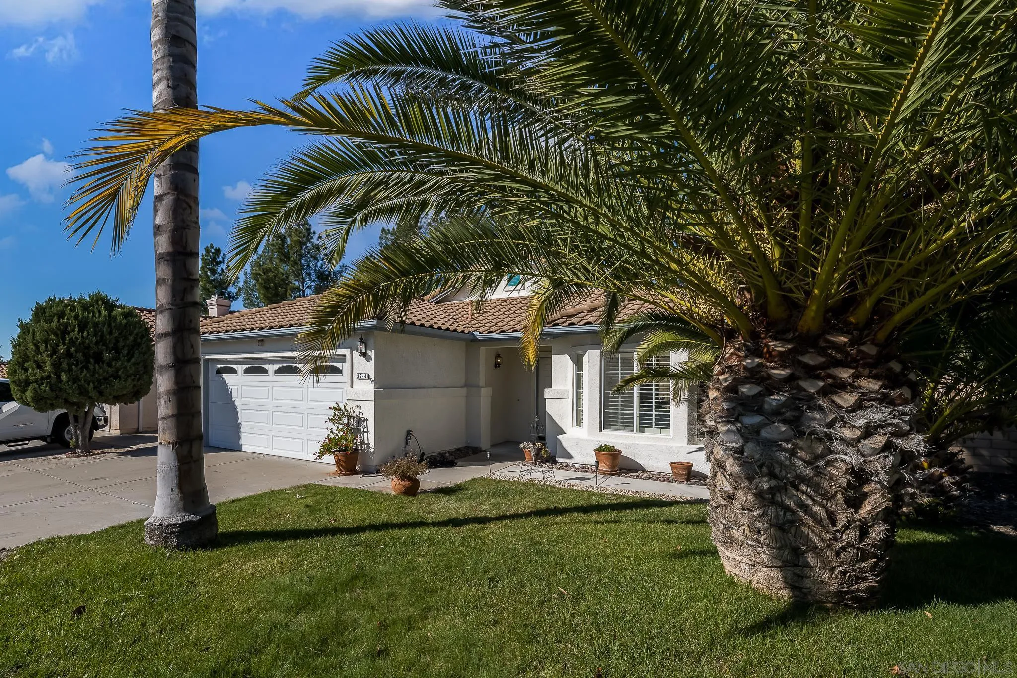 2344 Hyacinth Road Alpine, CA 91901 - Photo 3 of 29 a front view of a house with a garden and trees