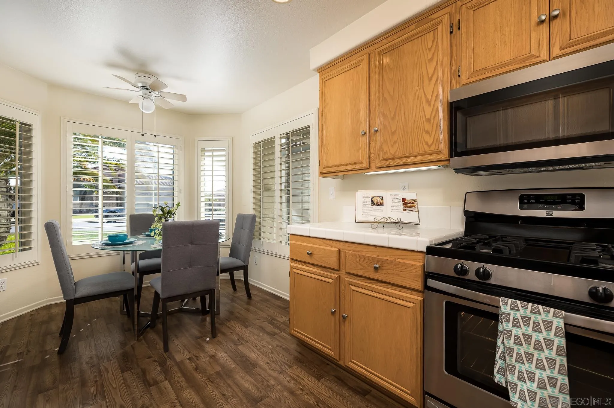 2344 Hyacinth Road Alpine, CA 91901 - Photo 8 of 29 a kitchen with stainless steel appliances a stove a sink cabinets and a dining table
