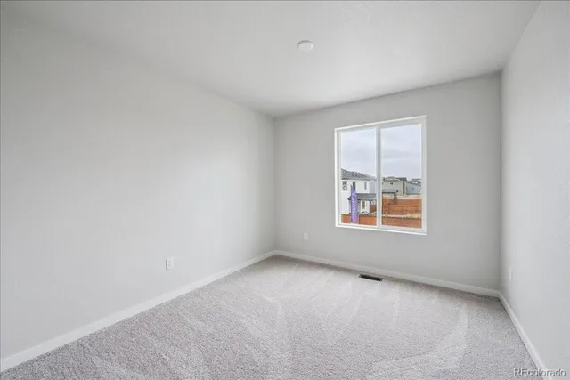 a view of an empty room and closet