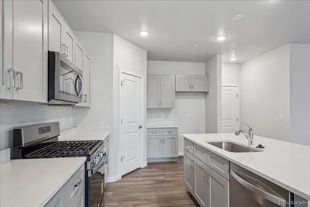 a kitchen with a sink stove and refrigerator