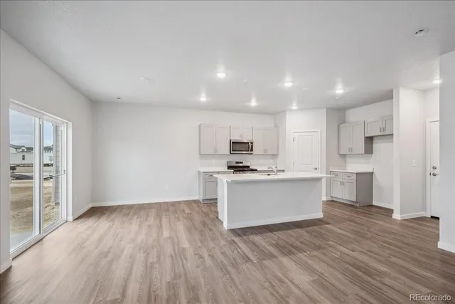 a kitchen with a white stove top oven and refrigerator