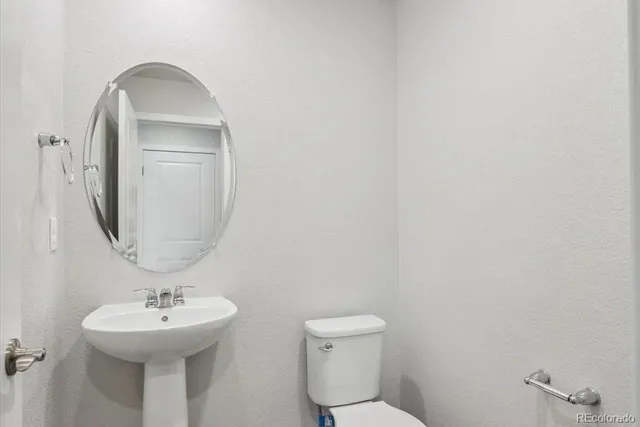 a bathroom with a sink a mirror and a toilet