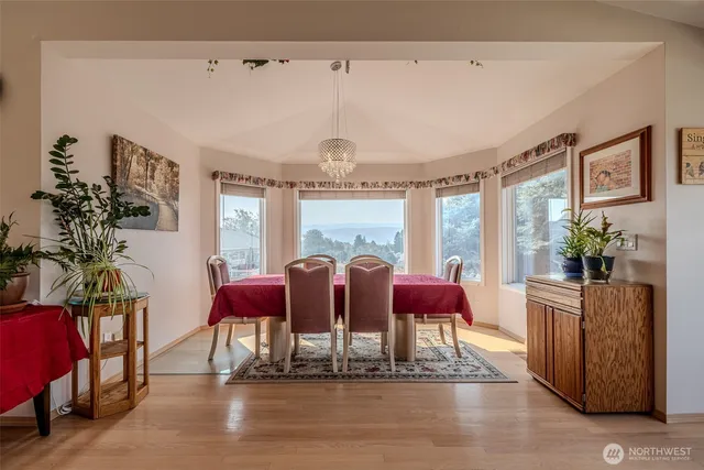 a living room with furniture kitchen view and a window