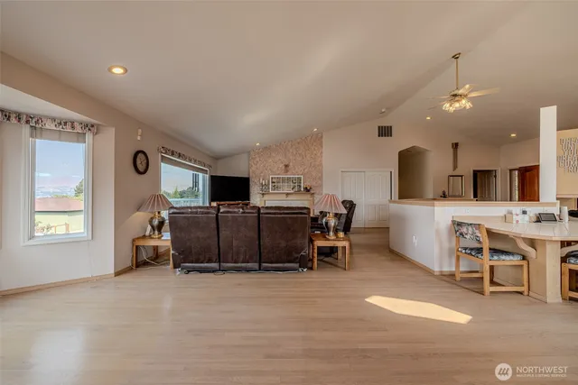a living room with furniture and kitchen view