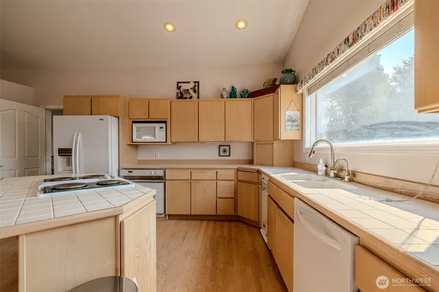 a kitchen with a sink a stove and a refrigerator