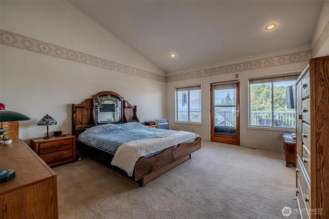 a bedroom with a bed and flat screen tv
