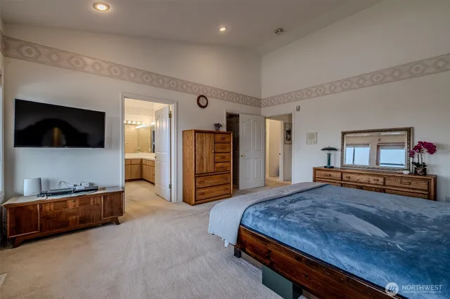 a spacious bathroom with a granite countertop sink mirror and bathtub
