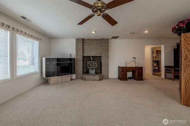 a living room with furniture kitchen view and a flat screen tv