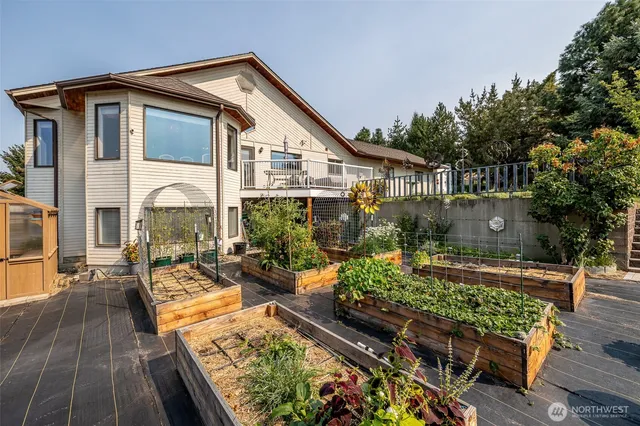 a view of a patio with table and chairs and potted plants