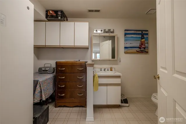 a bathroom with a toilet sink and shower