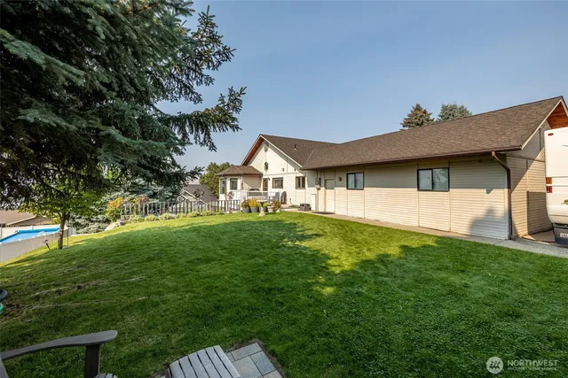 a view of a house with a yard and deck