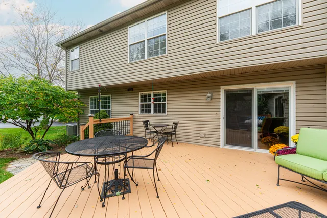 a view of a house with backyard and a sitting area